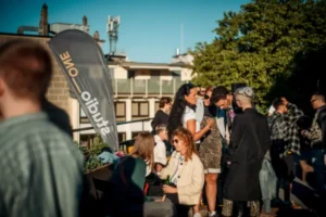 Gruppe von Menschen unterhält sich bei einer Veranstaltung im Freien.
